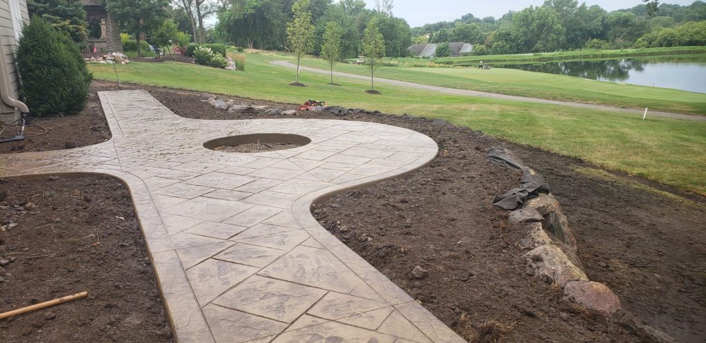 Decorative concrete patio walkway and fire pit - West Des Moines, IA - Installation